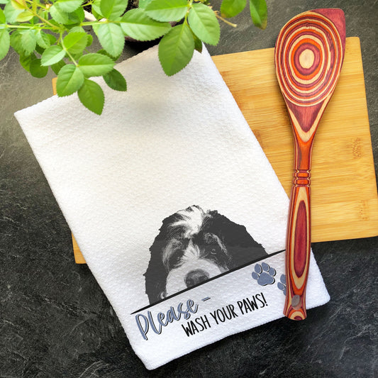 a wooden spoon sitting next to a towel on a cutting board