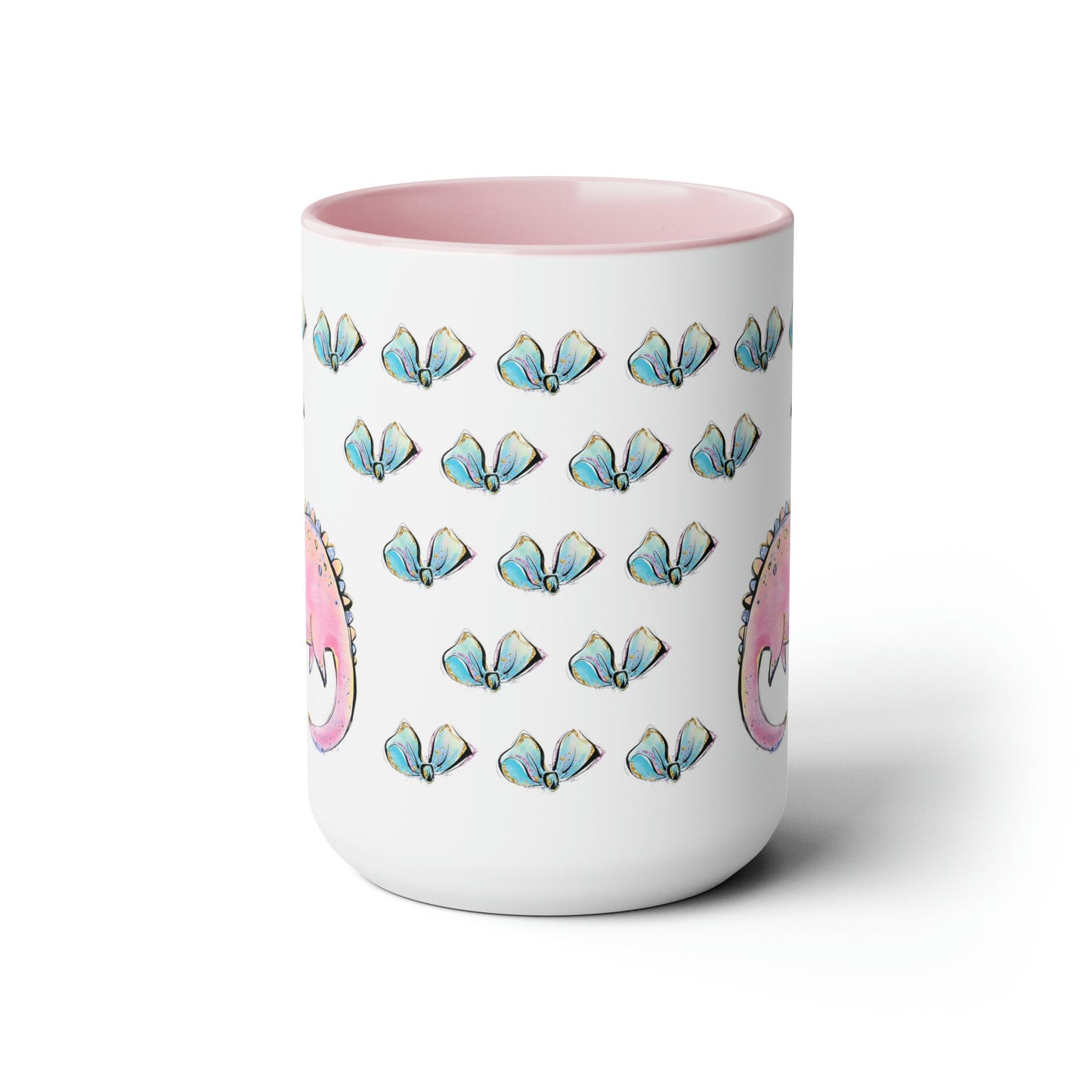 a pink and white coffee mug with a pattern of blue, pink, and white