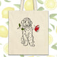 a tote bag with a drawing of a dog holding a rose