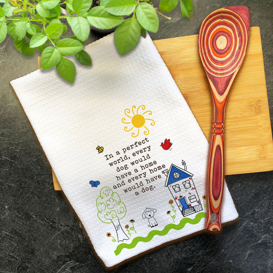 a tea towel with a spoon on a cutting board