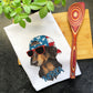 a tea towel with a dog wearing a hat and sunglasses